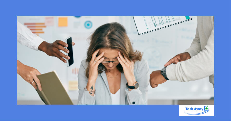 "Business owner with head in her hands. Overwhelmed by the amount of work."